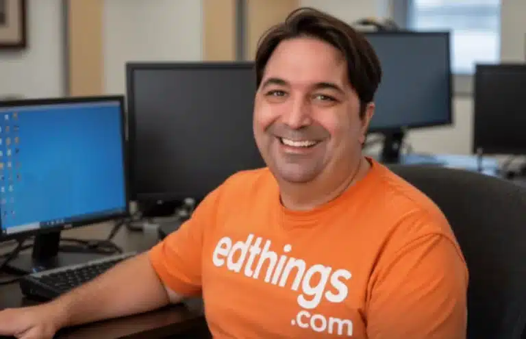 Smiling 5th grade teacher in a computer lab wearing an EdThings.com shirt